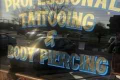 Gold leaf lettering at Taunton Tattoo, 2019