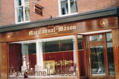 Gold leaf painted lettering with black shadow onto polished wood sign. London 1999